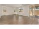 Bright open-concept living room with wood-look tile flooring and sliding glass doors, creating a welcoming and versatile space at 11623 W Green Dr, Youngtown, AZ 85363