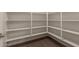 Walk-in pantry featuring custom shelving and wood-look flooring for organized storage at 11623 W Green Dr, Youngtown, AZ 85363