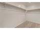 Carpeted walk-in closet with shelving, ideal for storing clothing and accessories at 11623 W Green Dr, Youngtown, AZ 85363
