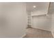 Walk-in closet featuring carpet and shelving, providing ample storage space at 11623 W Green Dr, Youngtown, AZ 85363