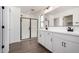Modern bathroom featuring a double vanity, quartz countertop, and glass-enclosed shower at 11627 W Green Dr, Youngtown, AZ 85363
