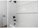 Bright bathroom boasts a tub with black fixtures and white subway tile surround at 11627 W Green Dr, Youngtown, AZ 85363