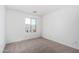 Bright bedroom featuring neutral carpet and a large window at 11627 W Green Dr, Youngtown, AZ 85363