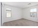 Bright bedroom featuring neutral carpet, white walls, and plenty of natural light at 11627 W Green Dr, Youngtown, AZ 85363