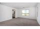 Bright bedroom features a carpeted floor and window overlooking the outdoors at 11627 W Green Dr, Youngtown, AZ 85363