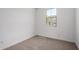 Bright, carpeted bedroom with a large window offering natural light at 11627 W Green Dr, Youngtown, AZ 85363