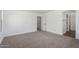 Spacious bedroom with neutral carpet and white walls for a bright, airy feel at 11627 W Green Dr, Youngtown, AZ 85363