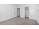 Bedroom features neutral carpet, white walls, and a closet at 11627 W Green Dr, Youngtown, AZ 85363