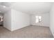 Bright, carpeted bedroom with a large window offering plenty of natural light and a view of the neighborhood at 11627 W Green Dr, Youngtown, AZ 85363