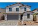 Beautiful two-story home with a gray garage door and a well-manicured lawn at 11627 W Green Dr, Youngtown, AZ 85363