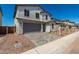 Attractive two-story home with a two-car garage, paved driveway, and fresh landscaping at 11627 W Green Dr, Youngtown, AZ 85363