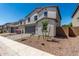 New two-story home with two-car garage, desert landscaping, and charming front yard at 11627 W Green Dr, Youngtown, AZ 85363