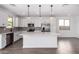 Bright kitchen with a center island, stainless steel appliances, and stylish pendant lighting at 11627 W Green Dr, Youngtown, AZ 85363