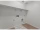 Well-lit laundry room with tile flooring, shelving, and washer/dryer hookups at 11627 W Green Dr, Youngtown, AZ 85363