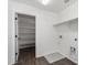 Bright, clean laundry room with shelving, washer/dryer hookups and wood-look tile flooring at 11627 W Green Dr, Youngtown, AZ 85363