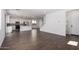 Bright, open-concept living space with tile flooring and seamlessly integrated kitchen and stairs at 11627 W Green Dr, Youngtown, AZ 85363