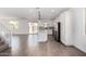 Open-concept living space featuring tile flooring, modern lighting, and a stylish kitchen at 11627 W Green Dr, Youngtown, AZ 85363