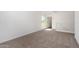 Upstairs loft area with plush carpeting, ample natural light, and a neutral color palette at 11627 W Green Dr, Youngtown, AZ 85363
