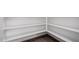 Walk-in pantry featuring custom shelving for organized storage and tile flooring at 11627 W Green Dr, Youngtown, AZ 85363