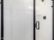 Modern shower with black trim, door, and fixtures including shower head and handle at 11627 W Green Dr, Youngtown, AZ 85363