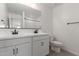 Modern bathroom with double sinks, a large mirror, and a toilet at 11631 W Green Dr, Youngtown, AZ 85363