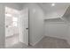 Bathroom with large vanity, next to a closet with shelves at 11631 W Green Dr, Youngtown, AZ 85363