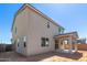 Exterior rear view of home with covered patio, stucco siding and blue sky at 11631 W Green Dr, Youngtown, AZ 85363