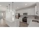 Well-lit kitchen with stainless steel appliances, white cabinetry, and a quartz-topped island at 11631 W Green Dr, Youngtown, AZ 85363
