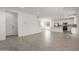 Open-concept living area with tile flooring, white walls, and a seamless flow into the kitchen at 11631 W Green Dr, Youngtown, AZ 85363
