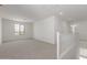 Bright, open living room with neutral carpet, large window, and white trim at 11631 W Green Dr, Youngtown, AZ 85363