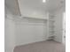 Spacious walk-in closet with shelving and hanging rods for storage at 11631 W Green Dr, Youngtown, AZ 85363