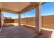 A covered back porch with concrete flooring and support columns, perfect for outdoor relaxing at 11635 W Beck Ave, Youngtown, AZ 85363