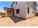 Exterior view showcasing the backyard with a covered porch and the home's architecture at 11635 W Beck Ave, Youngtown, AZ 85363