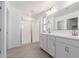 Modern bathroom with dual sinks, a spacious glass-enclosed shower, and neutral tile flooring at 11635 W Beck Ave, Youngtown, AZ 85363