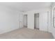 Bedroom with neutral carpet, white walls, and a closet with sliding doors for easy access at 11635 W Beck Ave, Youngtown, AZ 85363