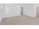 Bright bedroom featuring neutral carpet, white walls, and an open doorway to the hallway at 11635 W Beck Ave, Youngtown, AZ 85363