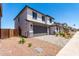 Beautiful two-story home featuring a gray roof, stone accents, and desert landscaping at 11635 W Beck Ave, Youngtown, AZ 85363