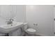 Modern half bathroom with pedestal sink, toilet, and stylish fixtures at 11635 W Beck Ave, Youngtown, AZ 85363