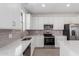 Kitchen boasts white cabinets and stainless steel appliances, creating a sleek and functional space at 11635 W Beck Ave, Youngtown, AZ 85363