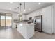 Bright kitchen with stainless steel appliances, white cabinets, tile backsplash, and a center island at 11635 W Beck Ave, Youngtown, AZ 85363