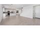 Open concept living area with bright white kitchen and stylish light fixtures at 11635 W Beck Ave, Youngtown, AZ 85363
