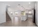 Open-concept living space features modern flooring and a kitchen with an island, perfect for entertaining at 11635 W Beck Ave, Youngtown, AZ 85363