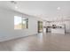 Spacious living room with modern flooring, ample natural light, and an open layout ideal for entertaining at 11635 W Beck Ave, Youngtown, AZ 85363