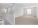Bright loft area with neutral carpeting and staircase with white railing at 11635 W Beck Ave, Youngtown, AZ 85363