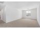 Spacious loft with neutral carpet and bright natural light from window at 11635 W Beck Ave, Youngtown, AZ 85363