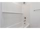 Clean white shower features a tub, tiled walls, a shower head, and modern fixtures at 11635 W Beck Ave, Youngtown, AZ 85363