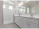 Elegant bathroom featuring a glass-enclosed shower and a double sink vanity with ample lighting at 12022 W Marguerite Ave, Avondale, AZ 85323