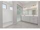 Elegant bathroom featuring a glass-enclosed shower and a double sink vanity with ample cabinet space at 12022 W Marguerite Ave, Avondale, AZ 85323