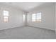 Neutral bedroom with carpet and multiple windows providing lots of natural light at 12022 W Marguerite Ave, Avondale, AZ 85323