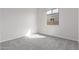 Bright bedroom with carpet flooring and large window at 12022 W Marguerite Ave, Avondale, AZ 85323